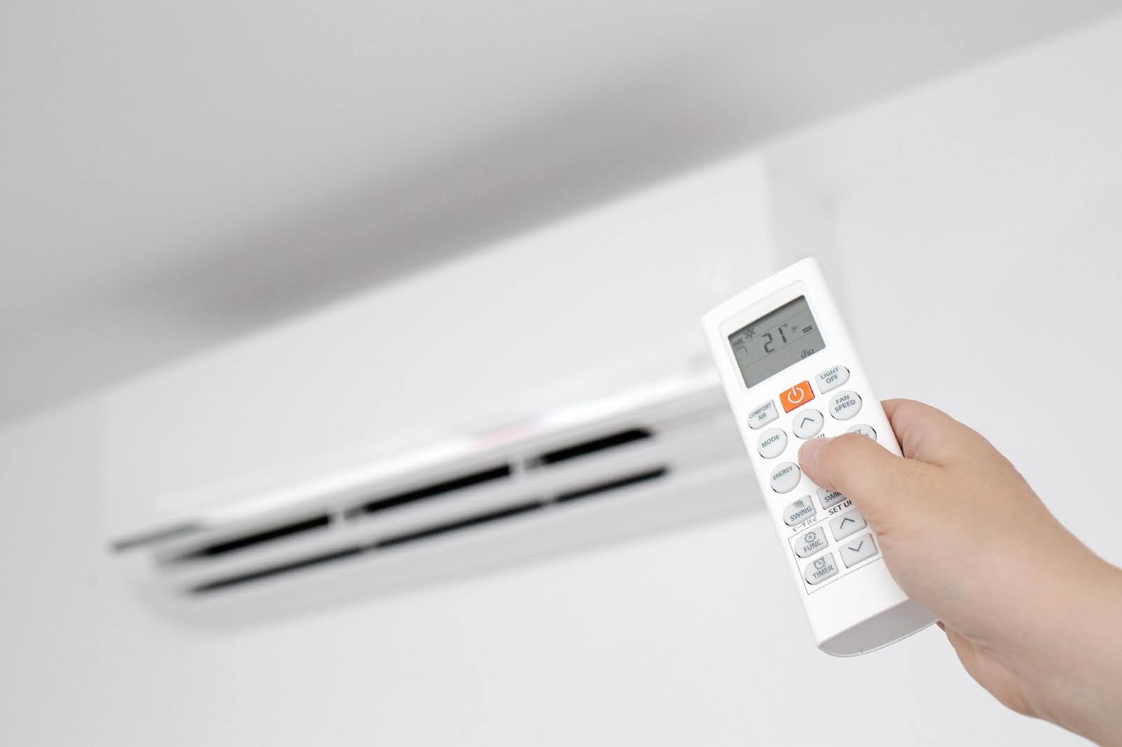 Ductless mini split indoor unit running dry mode, controlling humidity in a bright springtime room.