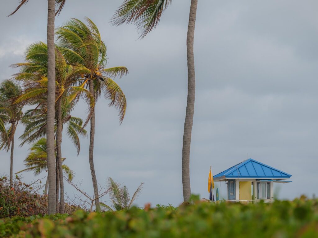 Hurricane-proof mini split outdoor unit secured with straps, protected from storm debris.